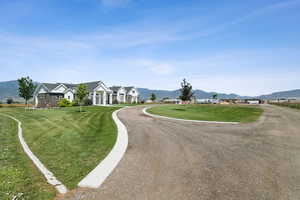 View of asphalt street featuring a mountain view