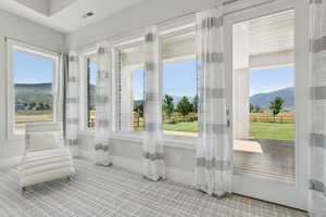 Primary Bedroom / Sunroom / solarium featuring a mountain view