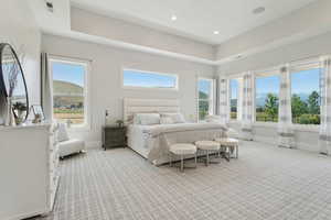 Primary Bedroom with light colored carpet and recessed lighting