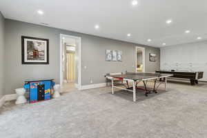 Rec room with recessed lighting and light carpet