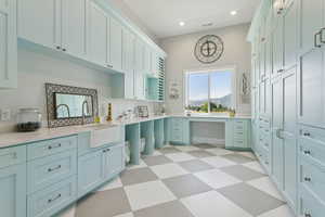 Laundry room with light floors, recessed lighting, an office area, and a mountain view