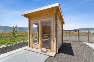 View of outdoor structure featuring a mountain view and a view of countryside