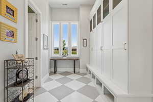 Mudroom with light flooring and baseboards