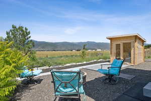 View of patio with a mountain view and an outdoor structure