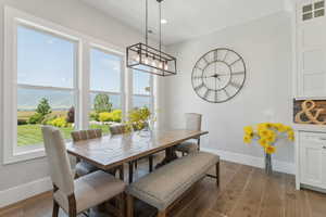 Dining room with dark wood-style floors, recessed lighting, and a mountain view