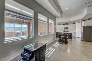 Dining space with finished concrete floors and recessed lighting