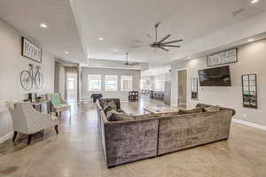 Living area with concrete floors, recessed lighting, a ceiling fan, and a textured ceiling