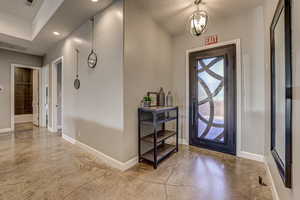 Foyer entrance with finished concrete floors and hanging lights