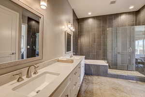 Full bath featuring a shower stall, double vanity, a garden tub, and recessed lighting