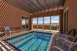 Outdoor pool featuring a pergola, a patio area, grilling area, and a mountain view