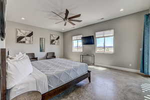 Bedroom with concrete flooring, ceiling fan, and recessed lighting