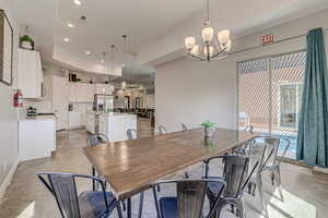 Dining area featuring suspended lighting and concrete floors