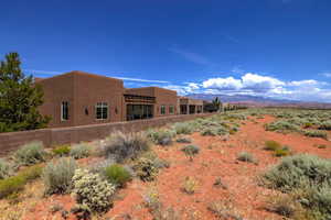 Back of property featuring stucco siding