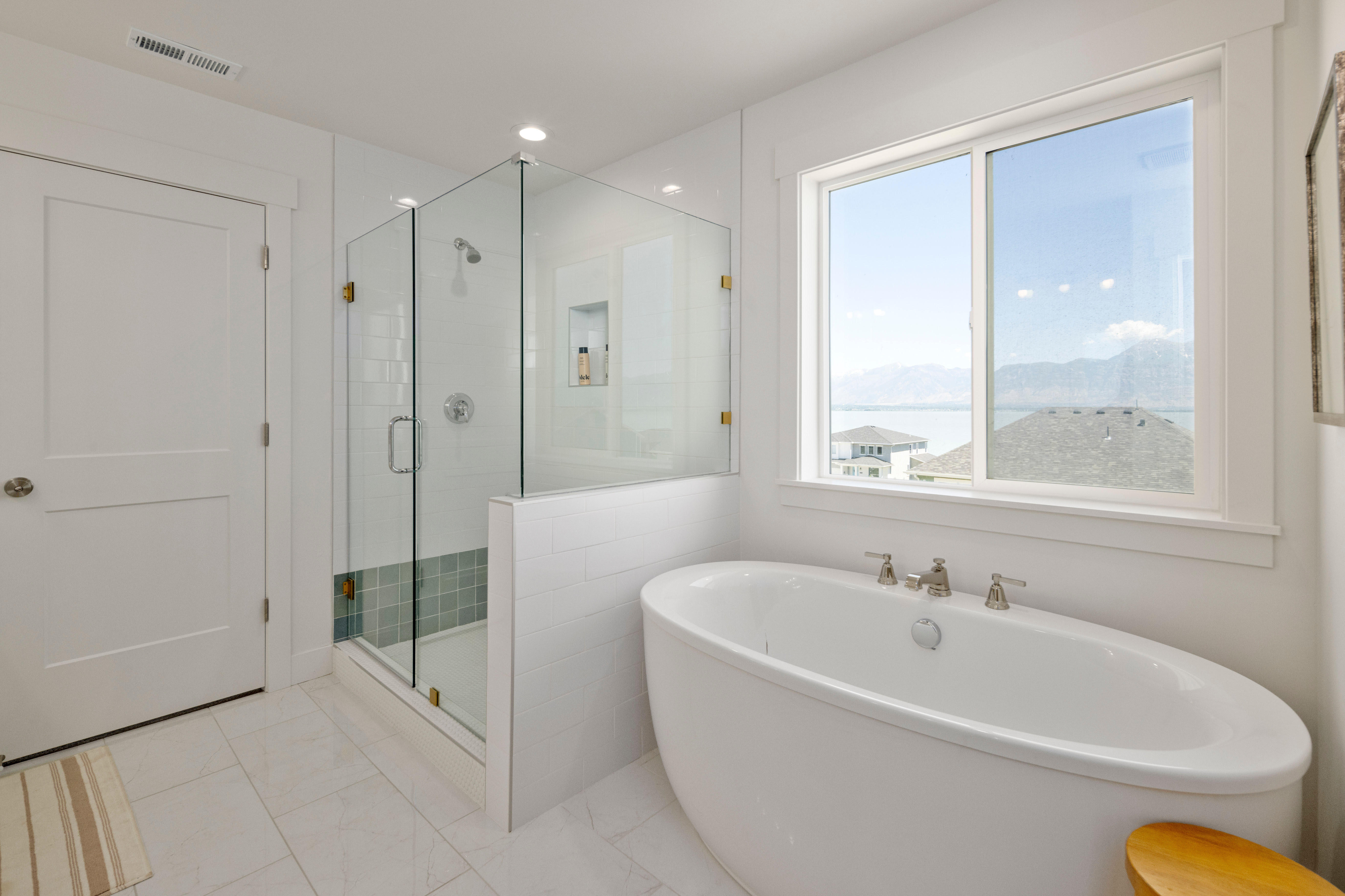 Full bathroom featuring a stall shower, a freestanding tub, and recessed lighting