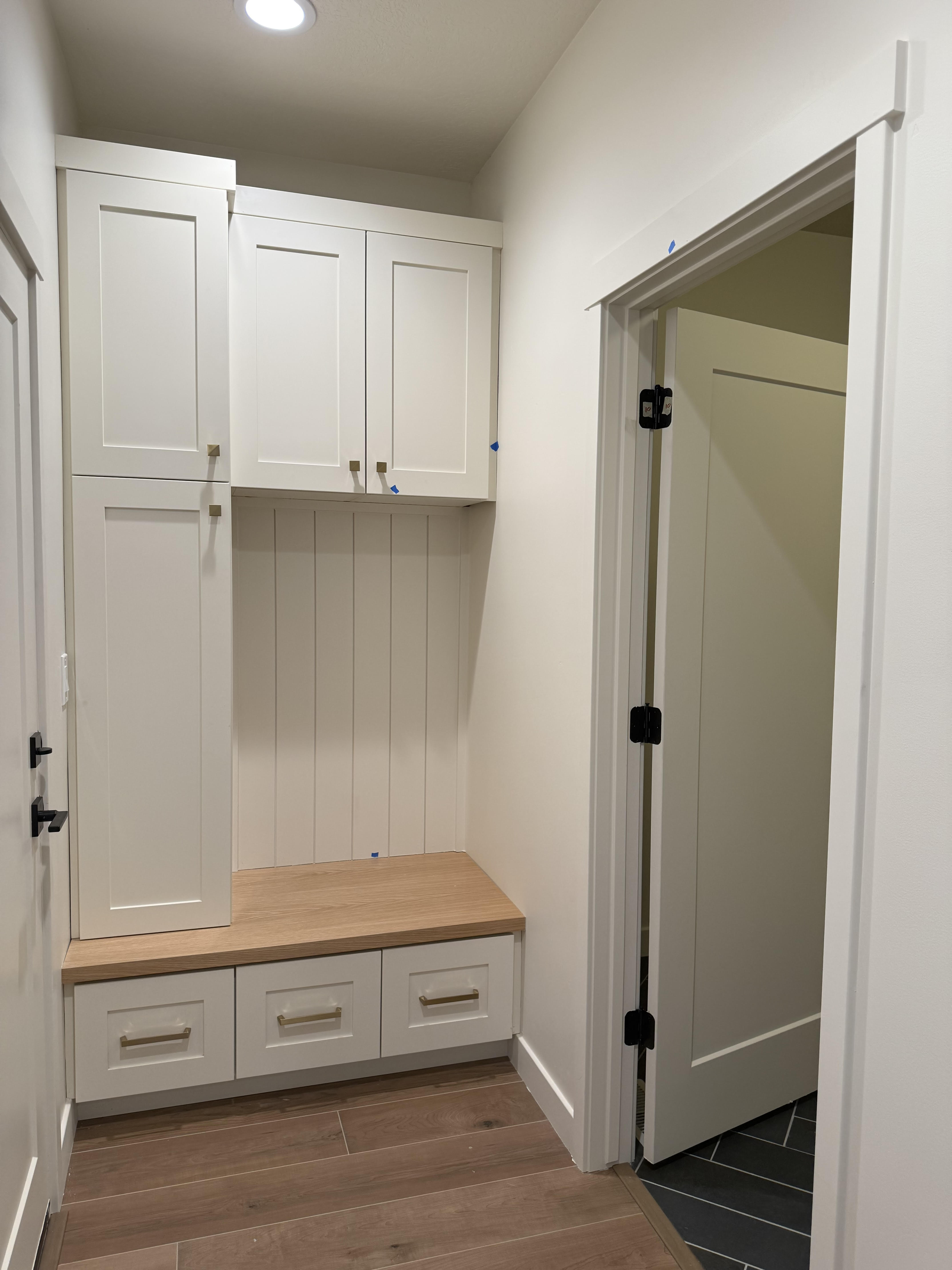Mudroom with dark wood-type flooring and baseboards