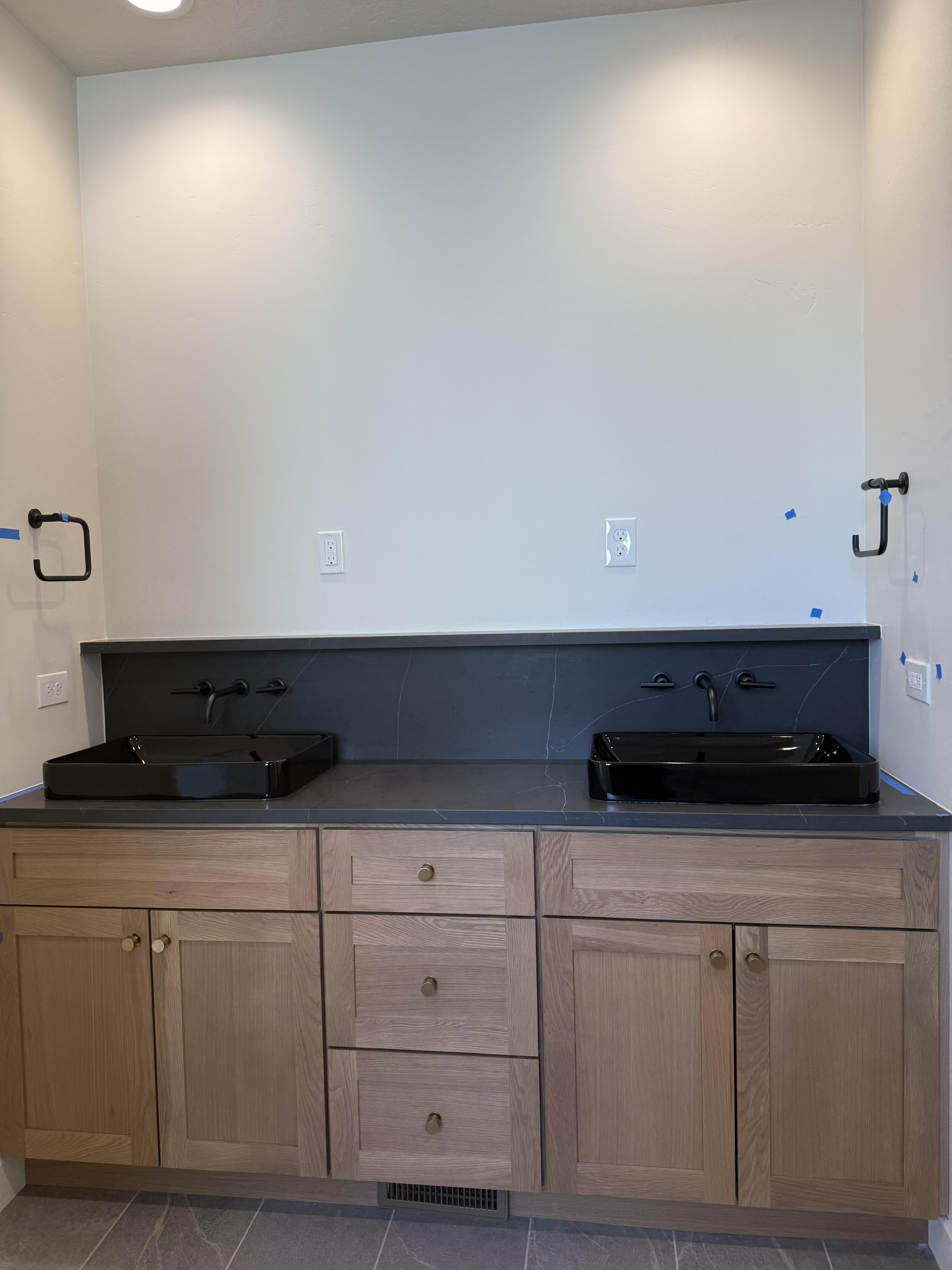 Full bathroom with double vanity and light tile patterned floors