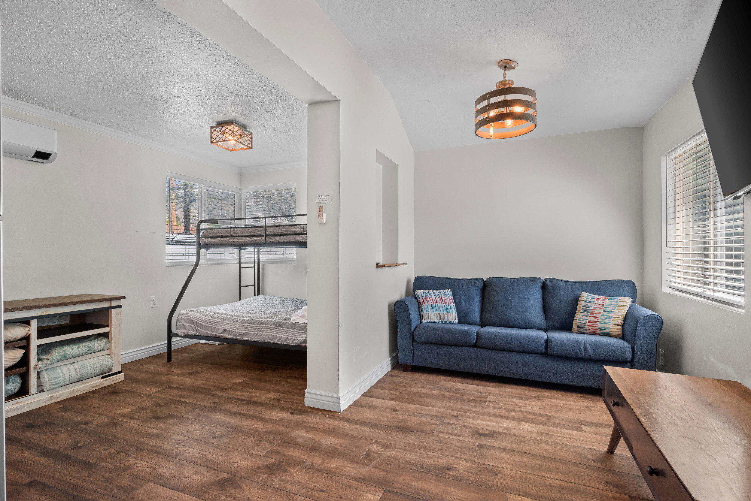 Open-concept living area featuring wood-finish flooring throughout