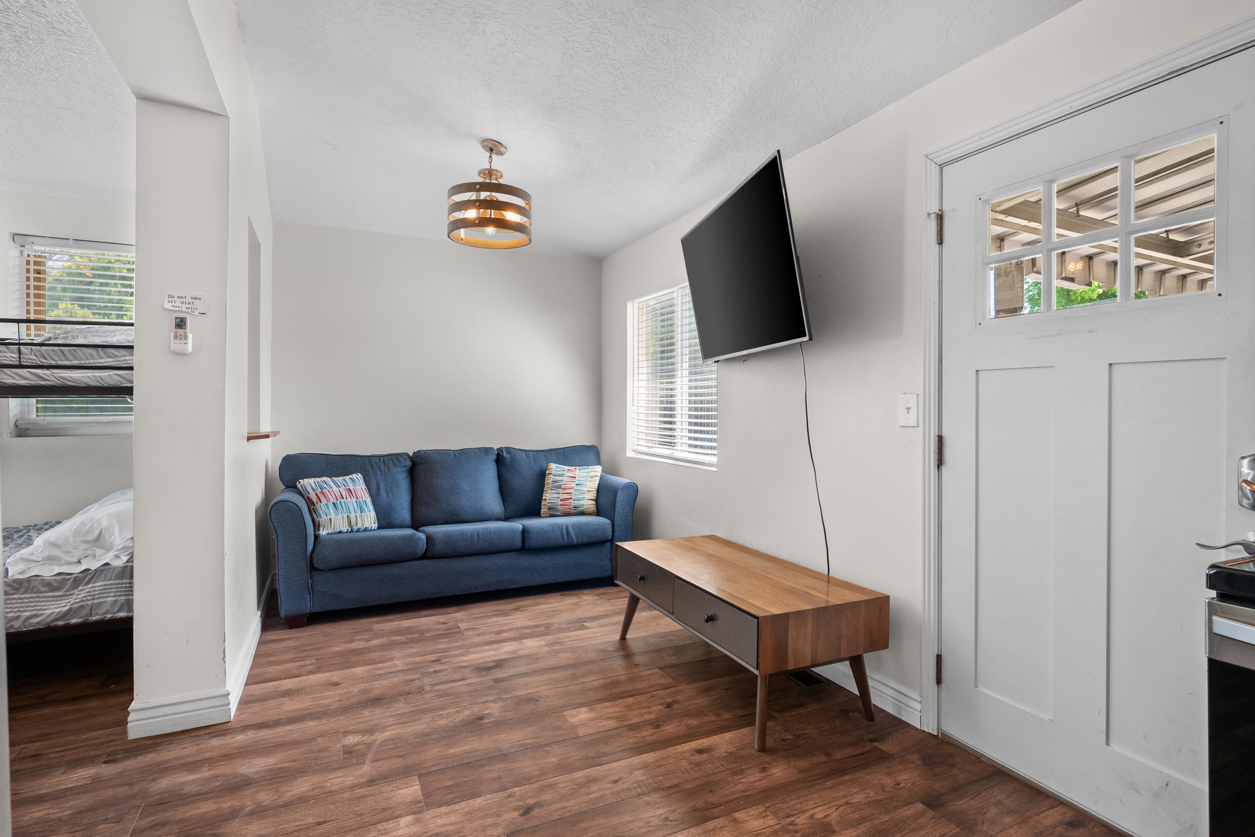 Hard-surface wood-finish flooring complements the light wall tones