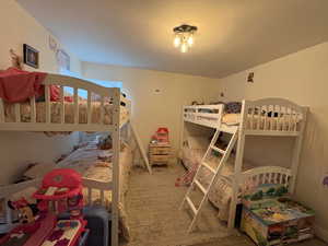 Bedroom featuring carpet floors and baseboards