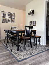 Dining space with wood finished floors and baseboards