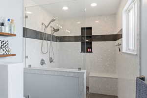 Bathroom with walk in shower and concrete flooring