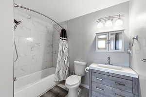 Bathroom featuring vanity and shower / bath combination with curtain
