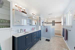 Full bathroom with walk in shower and double vanity