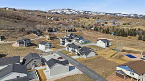 Aerial overview of property's location featuring nearby suburban area and mountains