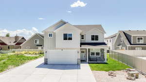 View of front of home featuring stone siding, a garage, driveway, and board and batten siding
