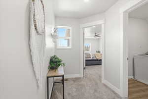 Corridor with washer / dryer and light carpet