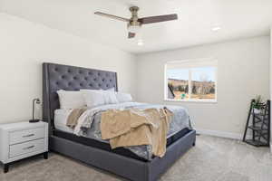 Bedroom featuring light colored carpet, a ceiling fan, and recessed lighting