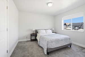 Bedroom featuring baseboards and carpet