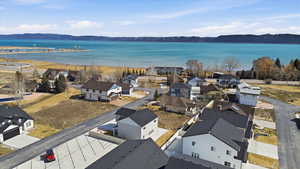 Aerial perspective of suburban area with a water and mountain view