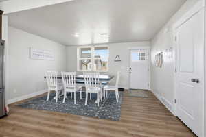 Dining room featuring light wood-style floors and baseboards