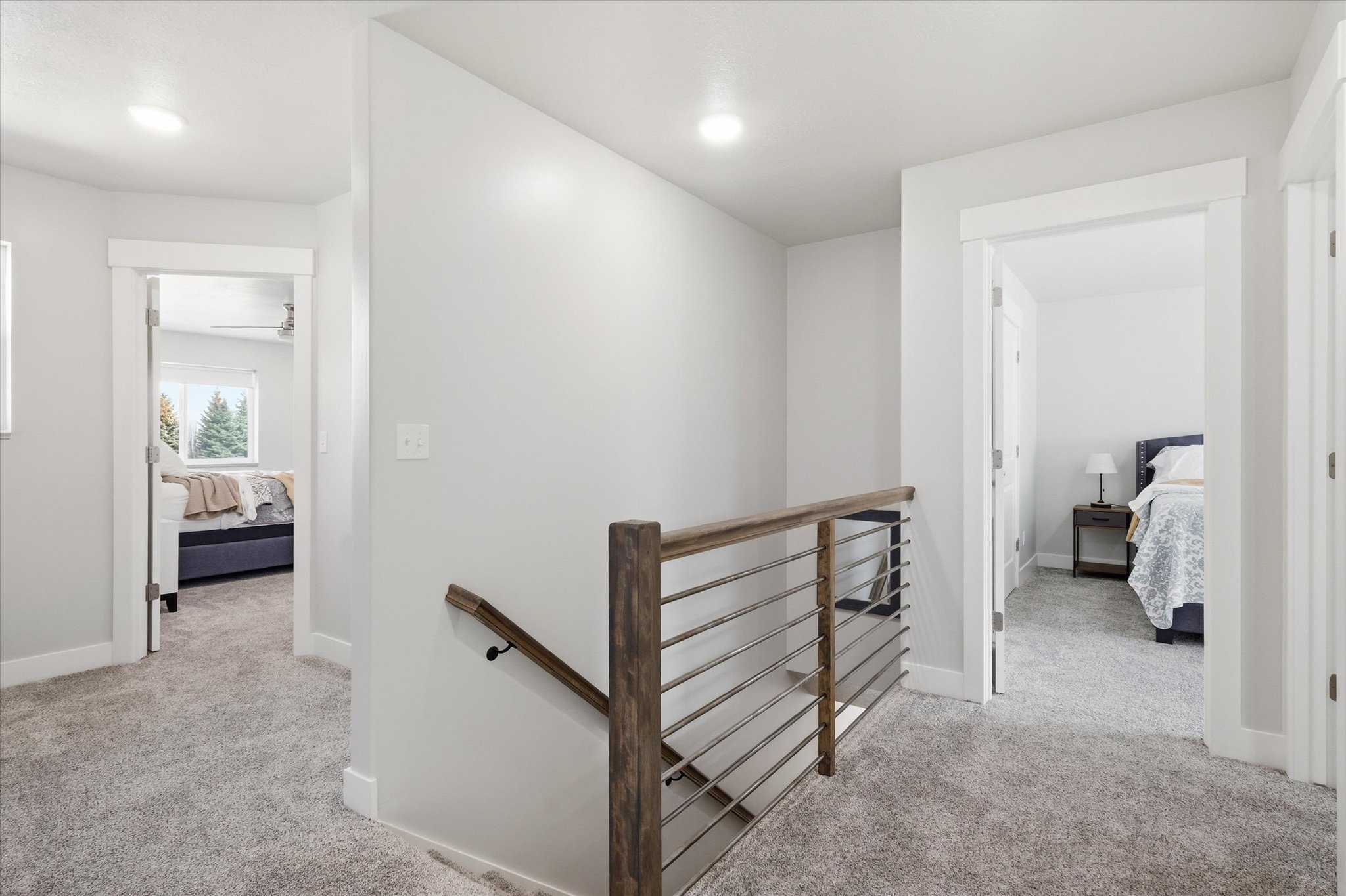 Hall with an upstairs landing and light carpet
