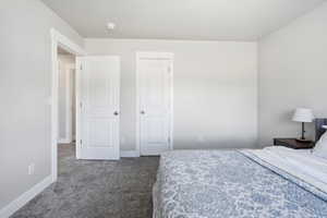 Bedroom with carpet floors and baseboards