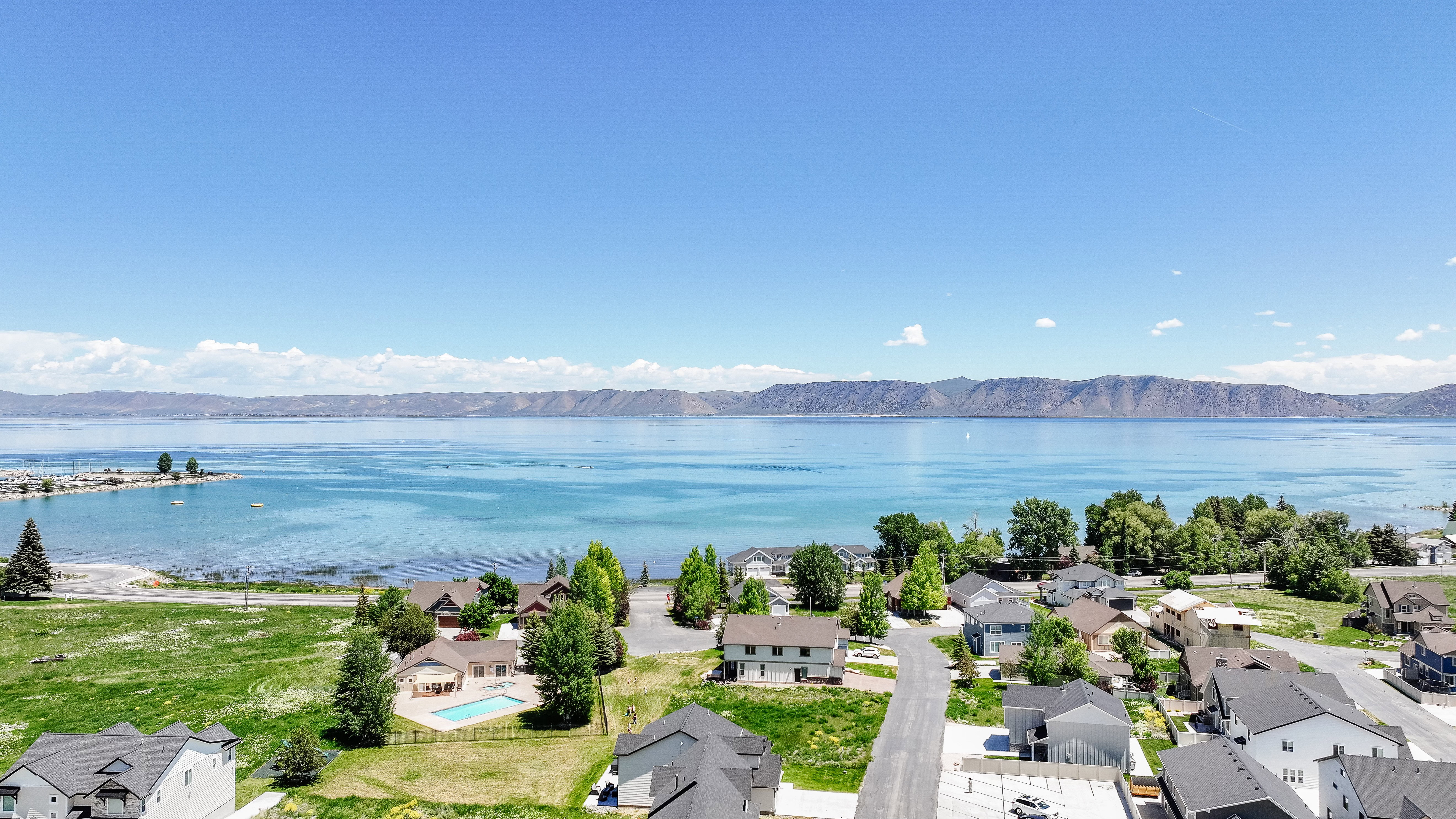 Aerial view of residential area featuring a water and mountain view