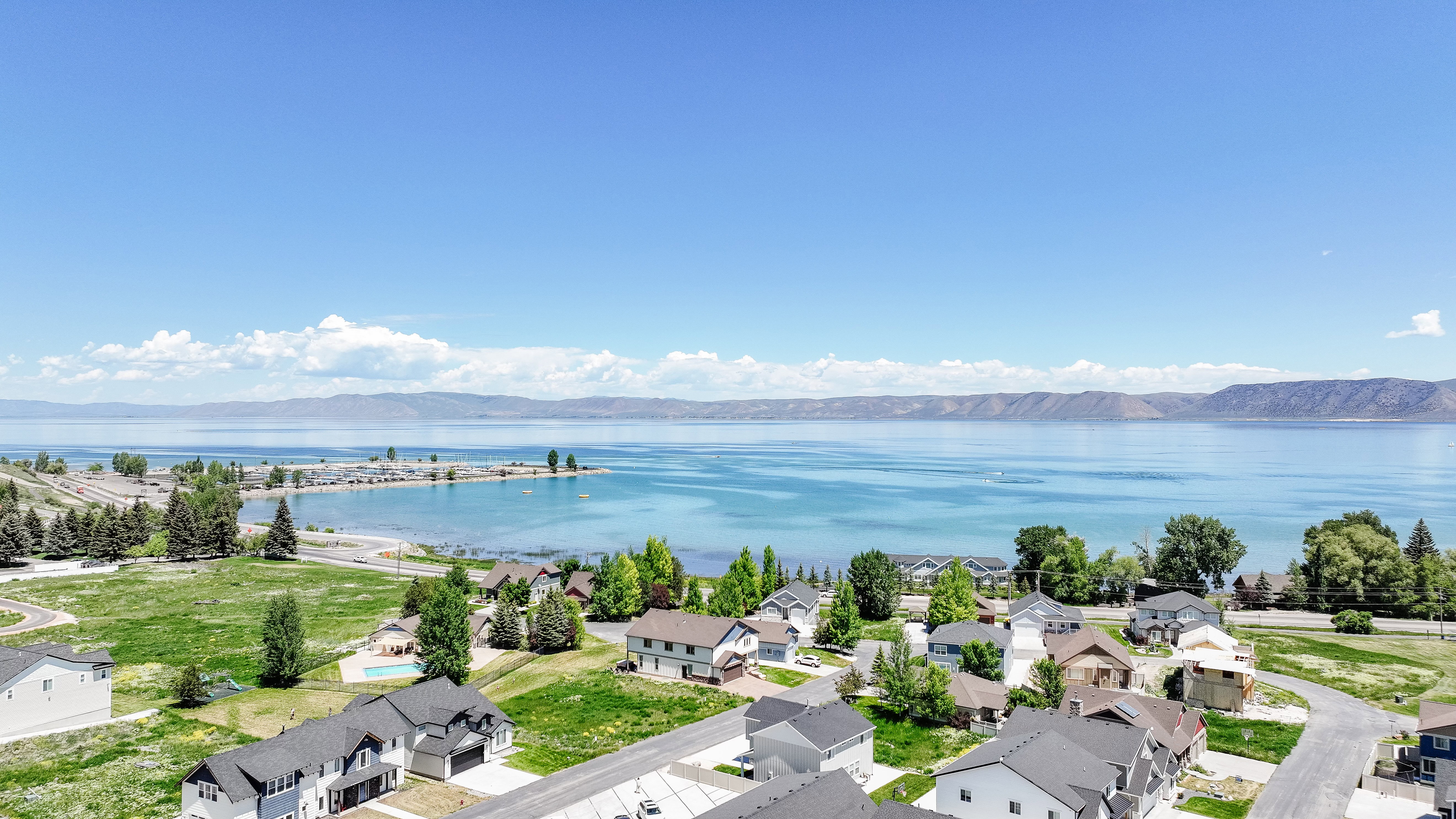 Aerial perspective of suburban area featuring a water and mountain view