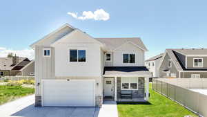 View of front of home with stone siding, a garage, driveway, roof with shingles, and board and batten siding