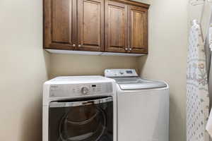 Laundry room with cabinet space and separate washer and dryer