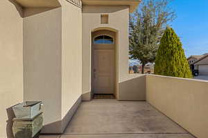 View of exterior entry with stucco siding