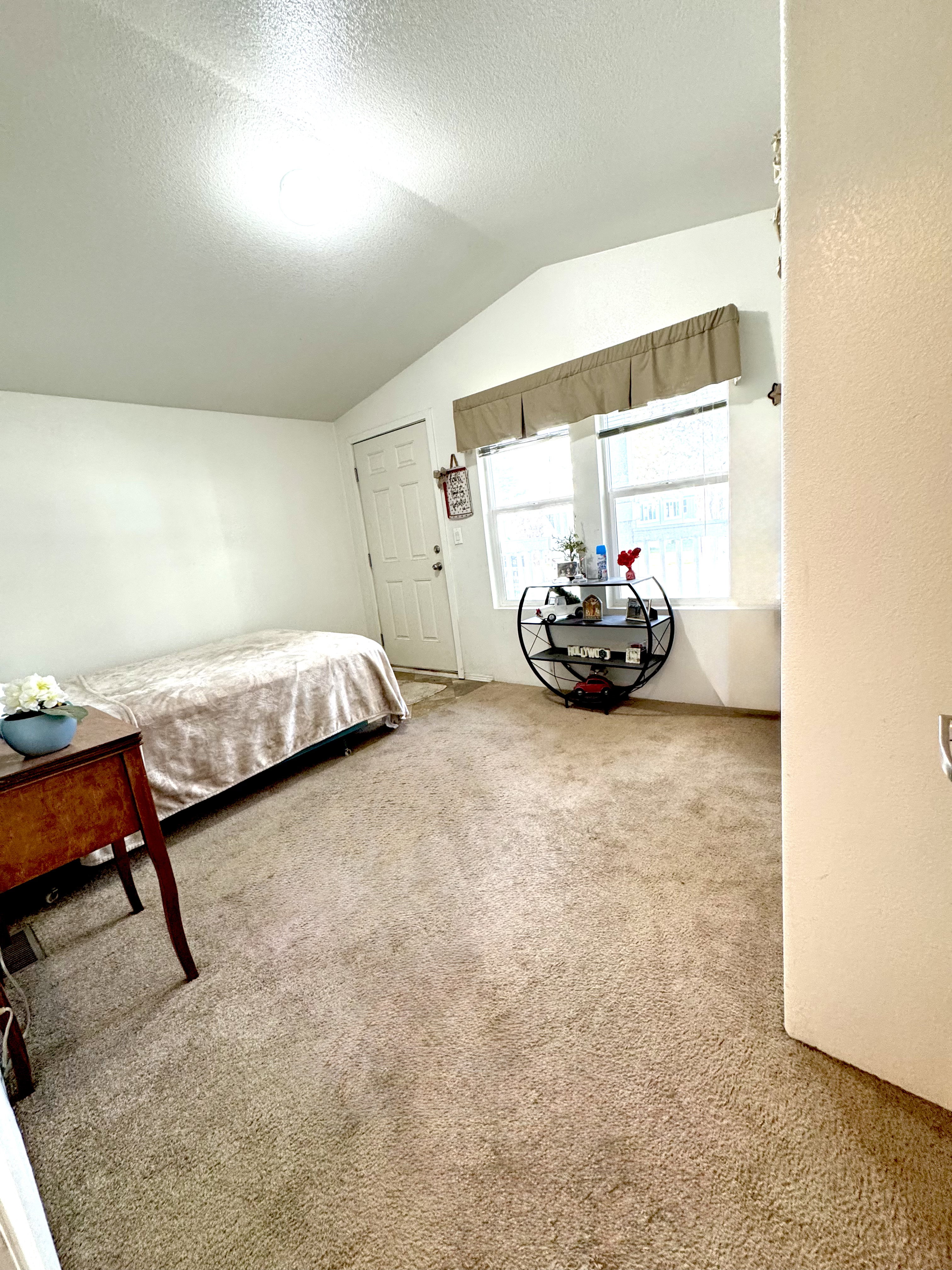 Bedroom with light colored carpet