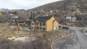 Rear view of property with a mountain view and 2 covered patios