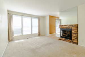 room with light tall windows to the south and fireplace