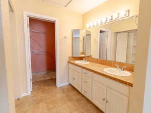 Bathroom with double vanity and a closet