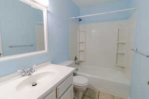 Full bathroom featuring vanity, light tile patterned floors, and shower / bathtub combination