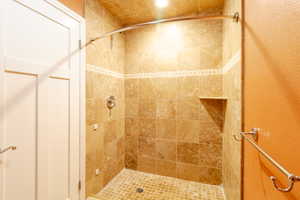 Bathroom with a stall shower and recessed lighting
