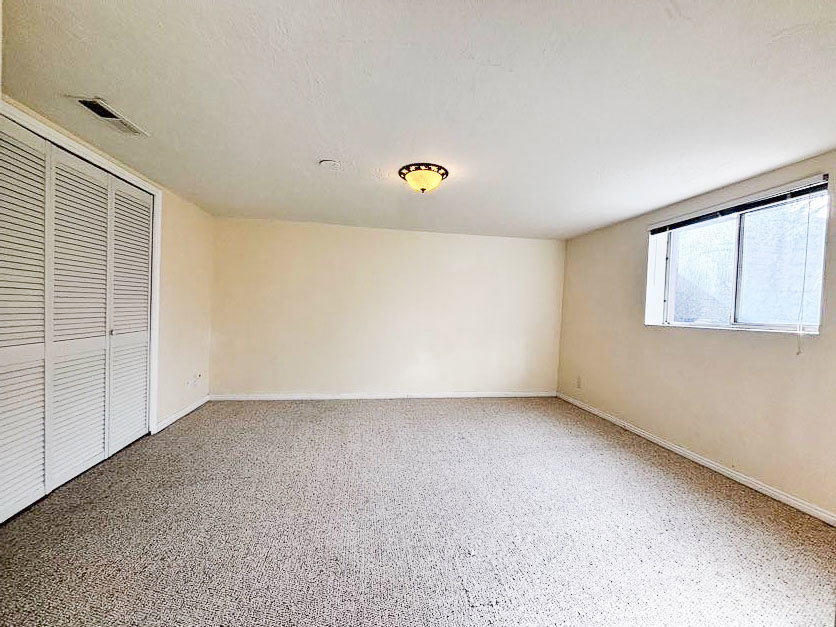 Large basement bedroom with daylight windows