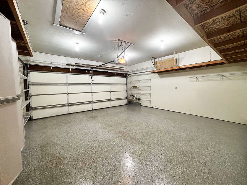 Garage featuring a garage door opener