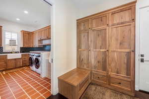 Laundry room with washer and clothes dryer, recessed lighting, and cabinet space